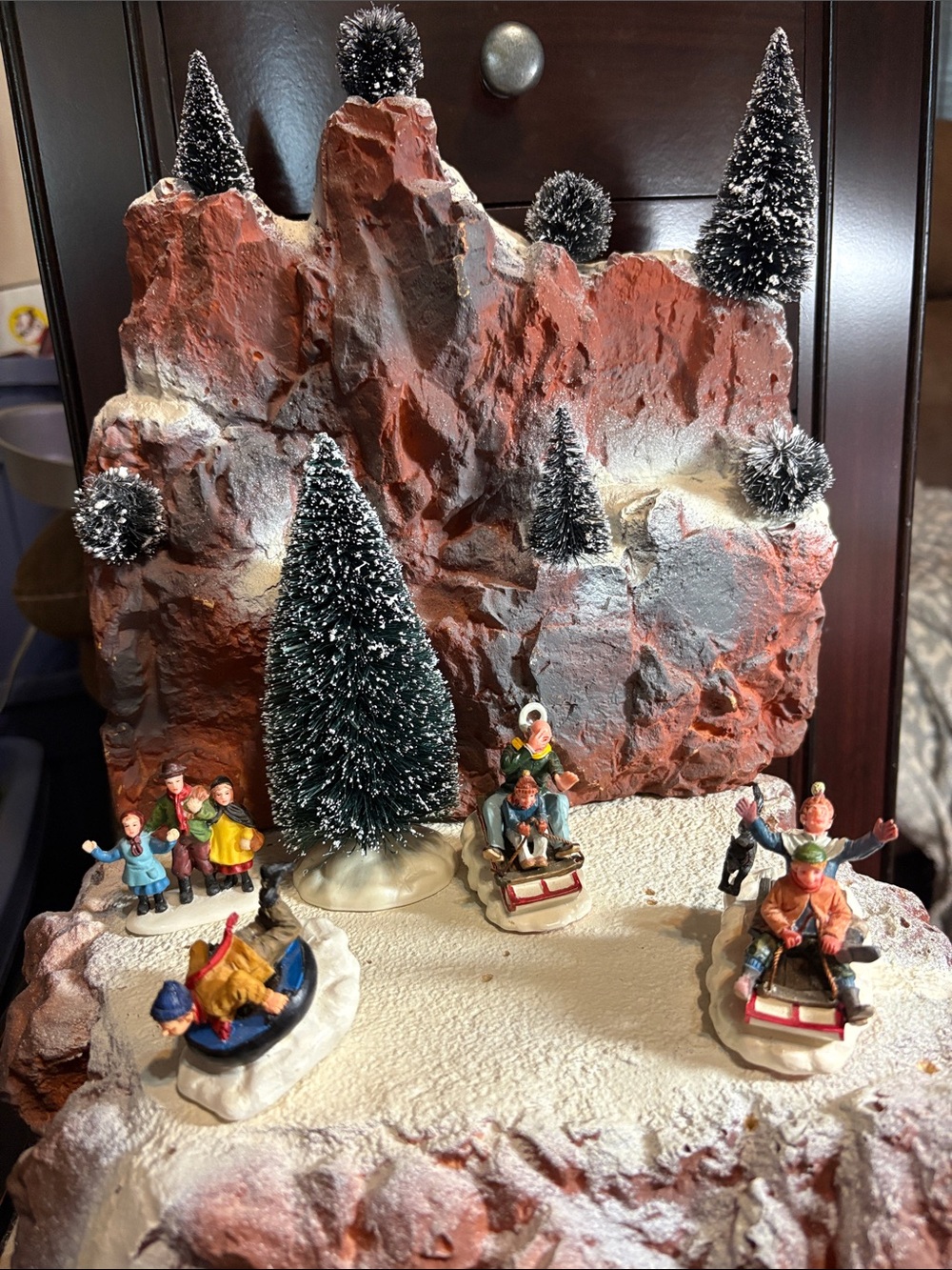Holiday Mountain Village Figurine Set - 4 Figurines sledding down the mountain.